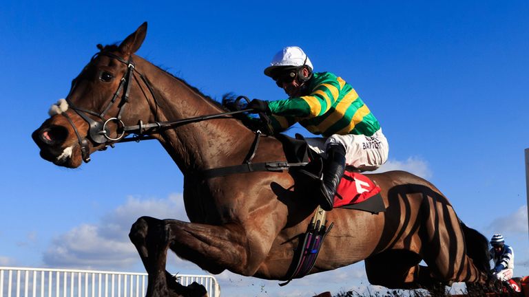 Minella Rocco ridden by Tony McCoy jumps the last on the way to winning The New Racing UK iPad App Novices' Hurdle at Kempton Park Racecourse, Surrey.