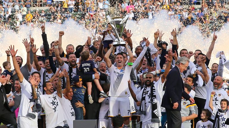 LA Galaxy captain Robbie Keane lifts the MLS trophy