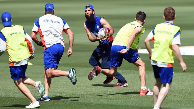 England's Moeen Ali passes a rugby ball during a training session at the Melbourne Cricket Ground