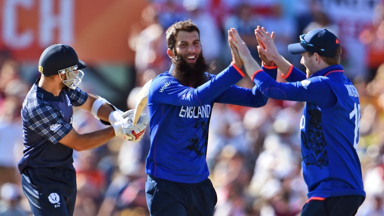 England spinner Moeen Ali (C) is congratulated by his captain Eoin Morgan (R)