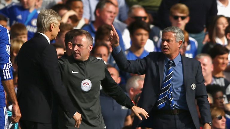 Fourth Official Jonathan Moss comes between Managers Arsene Wenger of Arsenal and Jose Mourinho manager of Chelsea during th