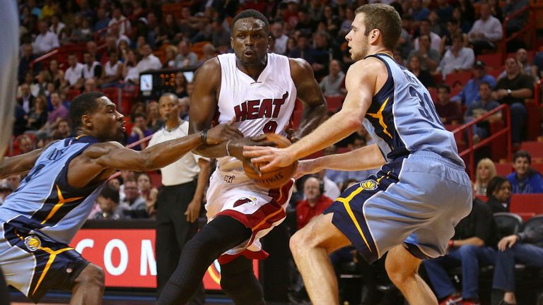 Luol Deng of the Miami Heat is guarded by Jon Leuer and Tony Allen of the Memphis Grizzlies