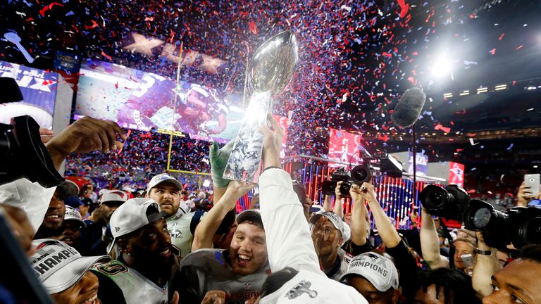 Members of the New England Patriots celebrate with the Vince Lombardi Trophy after defeating the Seattle Seahawks 28-24 in Super Bowl XLIX