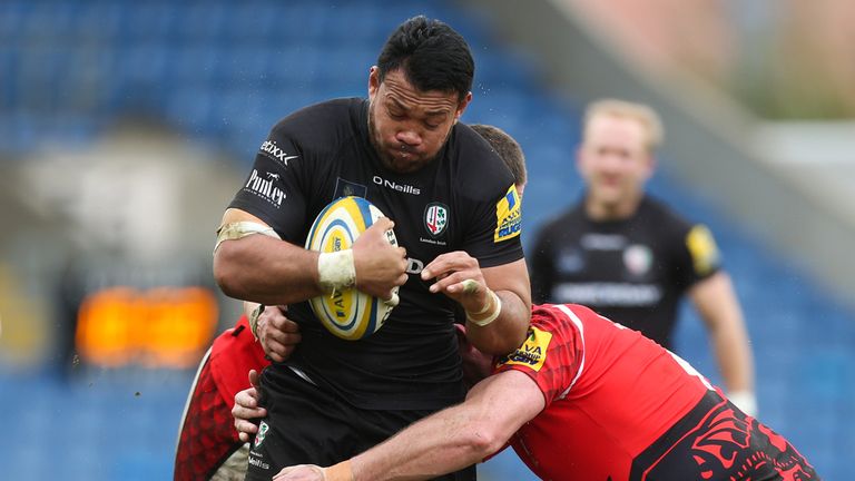 Ofisa Treviranus of London Irish is tackled by Carl Kirwan (L) and Dean Schofield (R) of London Welsh