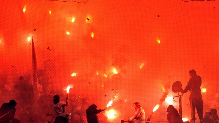 Supporters of Olympiakos light flares during a Greek Super League football game last year