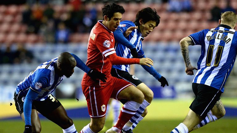 WIGAN, ENGLAND - FEBRUARY 24:  Peter Whittingham of Cardiff City is tackled by Marc-Antoine Fortune and Kim Bo-Kyung of Wigan Athletic during the Sky Bet C