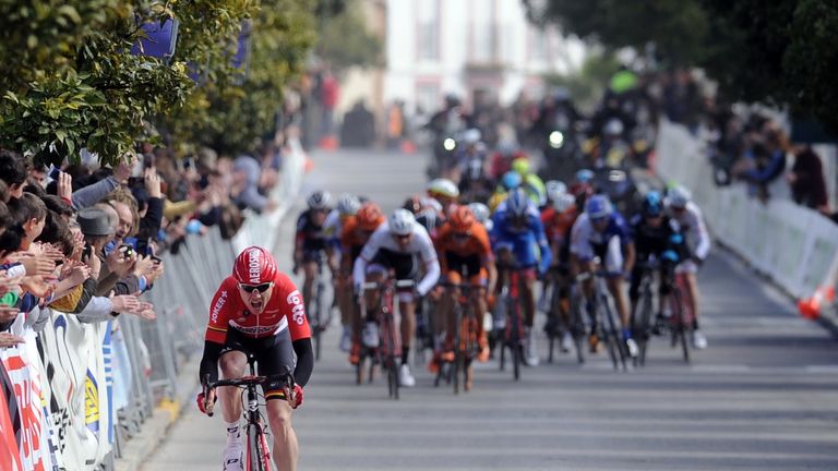 Lotto Soudal's cyclist Pim Ligthart (L) rides to the finish ahead of the pack during the first half stage 118.3km route from Rabida to Hinojos in Hinojos