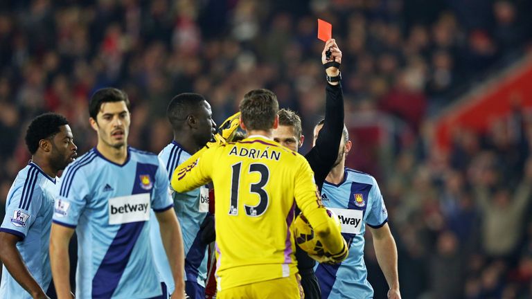 Adrian of West Ham receives a red card from referee Craig Pawson after diving on the ball outside of the area