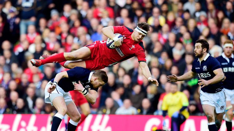 Dan Biggar of Wales-is taken out in the air by Finn Russell of Scotland during the RBS Six Nations match