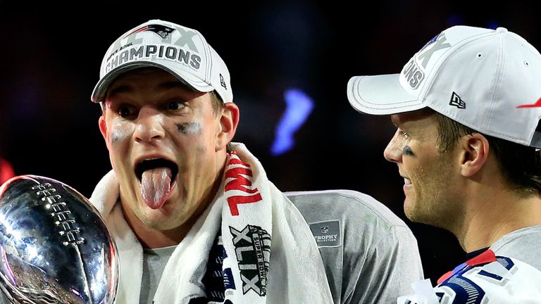 GLENDALE, AZ - FEBRUARY 01:  Rob Gronkowski #87 (L) and Tom Brady #12 of the New England Patriots celebrate while holding up the Vince Lombardi Trophy afte