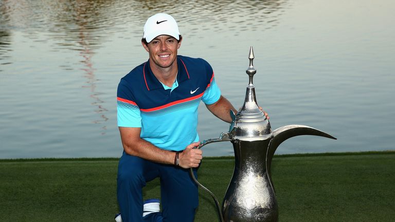 Rory McIlroy poses with the trophy in Dubai