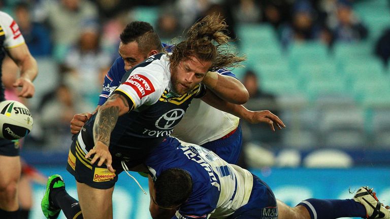 Ashton Sim of the North Queensland Cowboys offloads the ball during a NRL match between the Canterbury Bulldogs