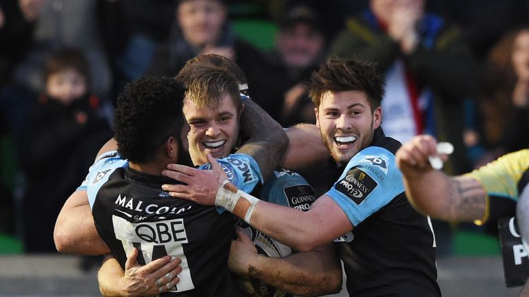 Glasgow hooker Pat MacArthur is congratulated after scoring a try against the Ospreys