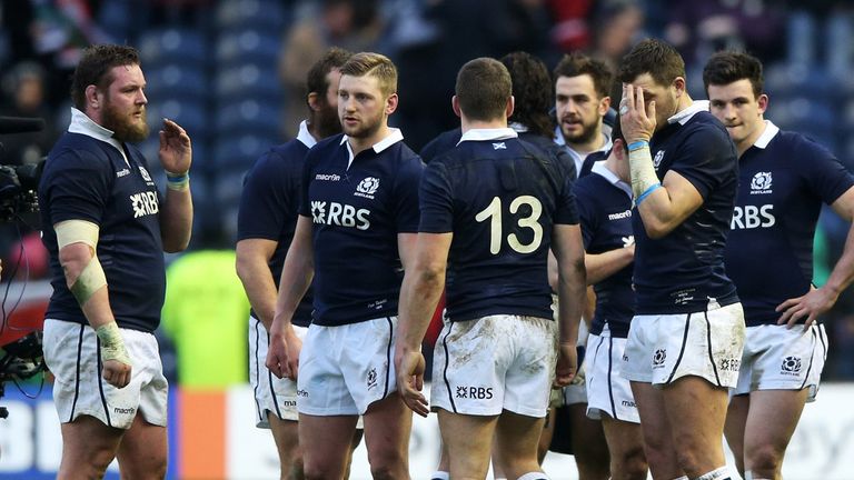 Dejected Scotland players look on following their team's 26-23 defeat
