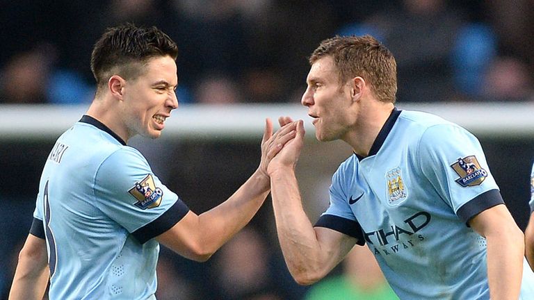 Manchester City's James Milner (centre) celebrates scoring his teams first goal against Hull City with Samir Nasri (left)