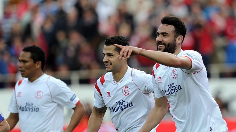 Sevilla's midfielder Vicente Iborra (R) celebrates with Sevilla's midfielder Vitolo (C) and Sevilla's Colombian forward Carlos Bacca