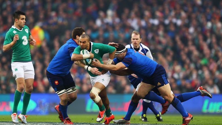Simon Zebo of Ireland is tackled by Damien Chouly (2L) and Guilhem Guirado of France (R)
