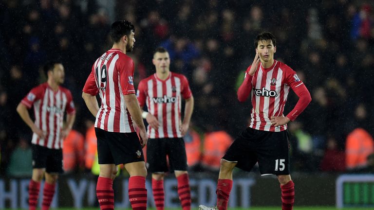 Dejected Southampton players look on after conceding a goal