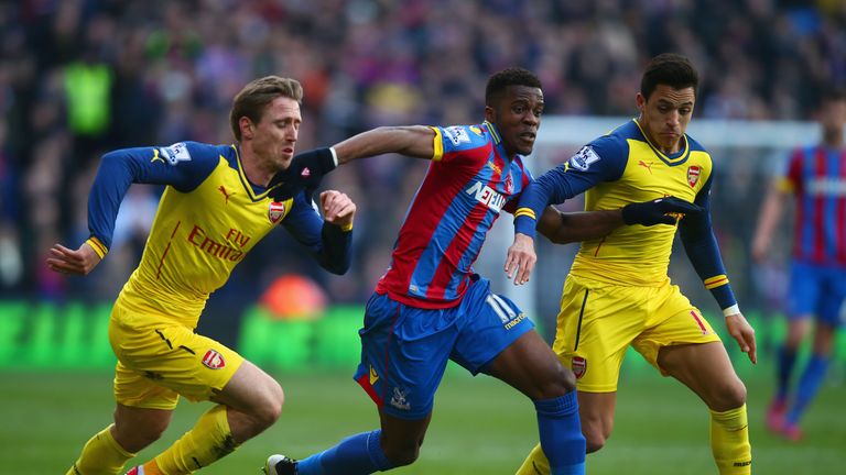 Wilfried Zaha of Crystal Palace takes on Alexis Sanchez (R) and Nacho Monreal of Arsenal during the Barclays Premier League