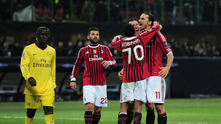 Zlatan Ibrahimovic of AC Milan celebrates scoring his penalty with team mates during the UEFA Champions League round of 16