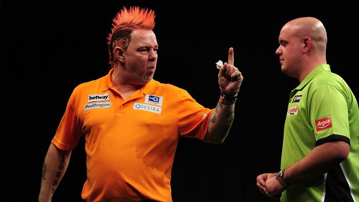 Peter Wright of Scotland (L) celebrates winning a leg against Michael van Gerwen of Holland during The Betway Premier League Darts, Exeter