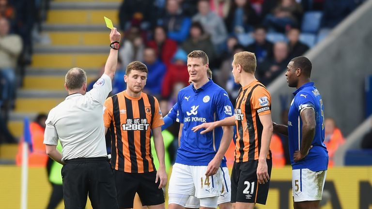 Ref Jon Moss books Alex Bruce during Hull's goalless draw at Leicester