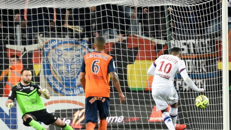 Lyon's French forward Alexandre Lacazette (R) scores from a penalty during the French L1 football match between Montpellier and Lyon