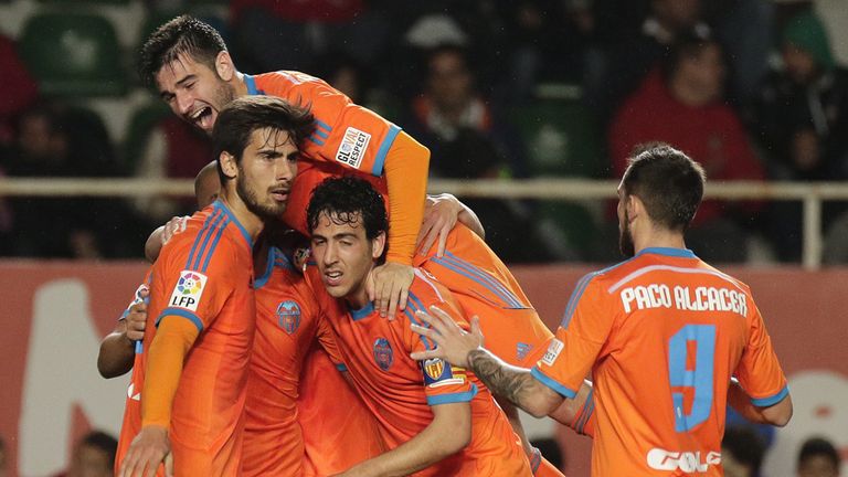 Valencia's midfielder Andre Gomes (left) celebrates a goal with teammates against Elche