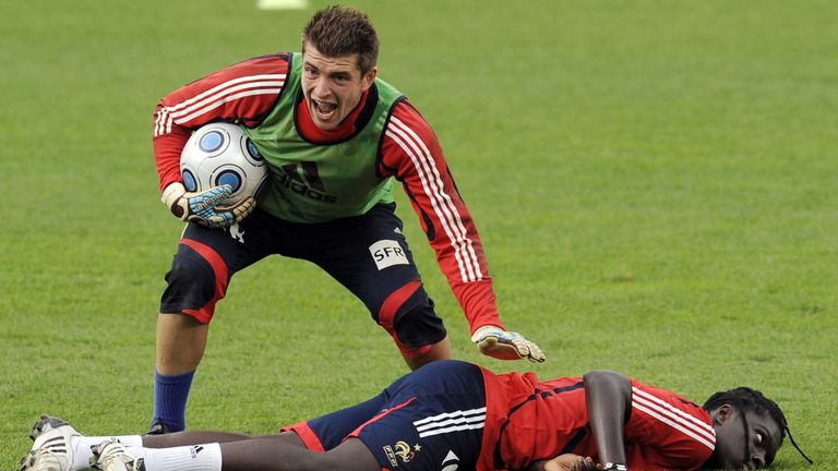 French national football team forward Bafetimbi Gomis (R) is helped by French Goalkeeper Cedric Carrasso after a vagal attack during a training session