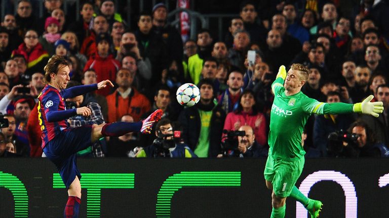 Ivan Rakitic of Barcelona scores the opening goal past Joe Hart of Manchester City