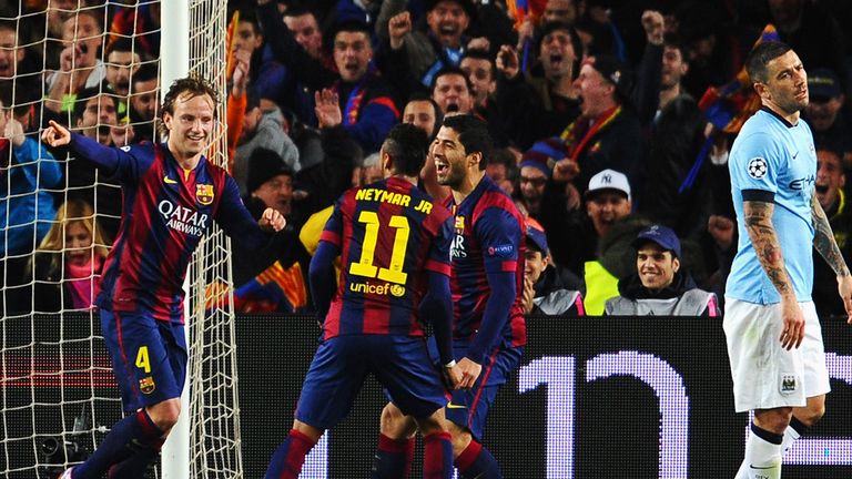 Ivan Rakitic of Barcelona (L) celebrates scoring the opening goal with Neymar and Luis Suarez of Barcelona