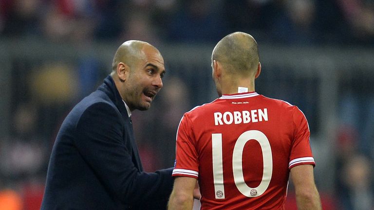 Bayern Munich's Spanish head coach Pep Guardiola talks with Dutch midfielder Arjen Robben