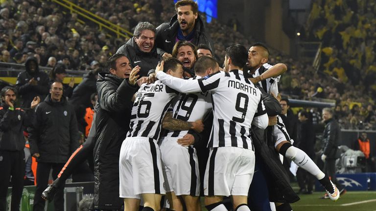 Juventus' Carlos Tevez celebrates scoring with his team-mates scores the 0-1 goal during the Round of 16 second-leg Champions League football match