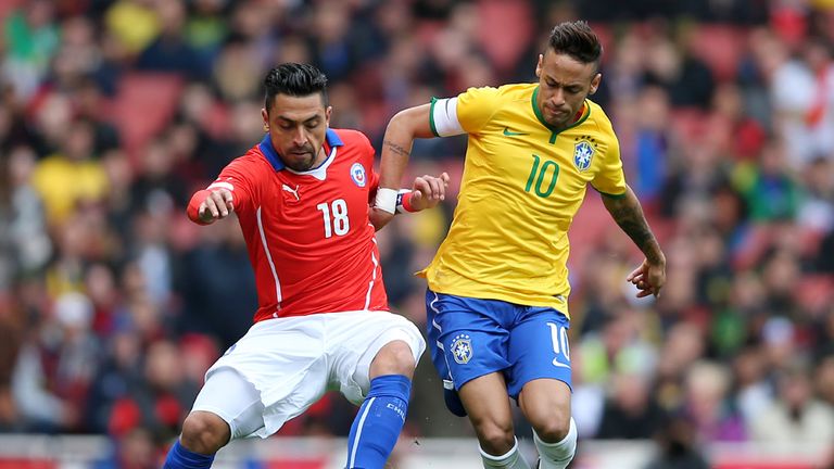Gonzalo Jara of Chile and Brazil's Neymar compete for the ball during the international friendly between Brazil and Chile