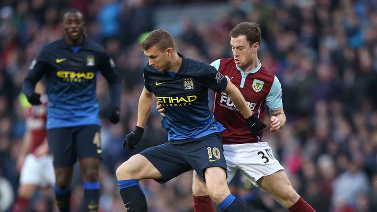 Burnley's Ashley Barnes (right) and Manchester City's Edin Dzeko (left) battle for the ball during the Barclays Premier League match at Turf Moor, Burnley.