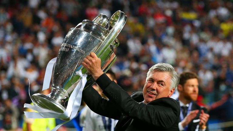 Carlo Ancelotti celebrates with the Champions League trophy.