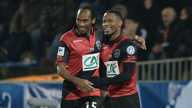 Guingamp's French midfielder Claudio Beauvue (R) celebrates with Guingamp's French defender Jeremy 