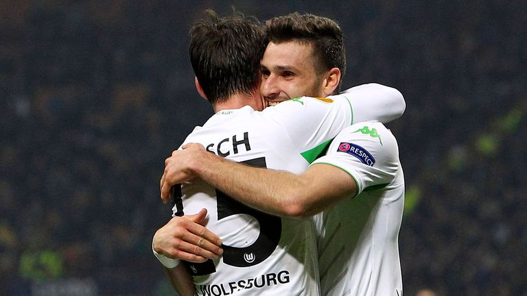 Daniel Caligiuri (R) of VfL Wolfsburg celebrates with his team-mate Christian Trasch (L) after scoring the opening goal during th