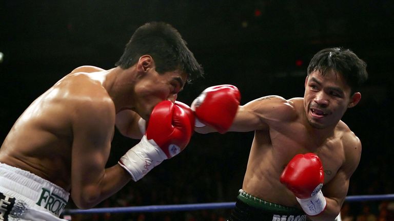 LAS VEGAS - JANUARY 21:  (R-L) Manny Pacquiao of the Phillippines throws a right on Erik Morales of Mexico during their Super Featherweight Championship fi