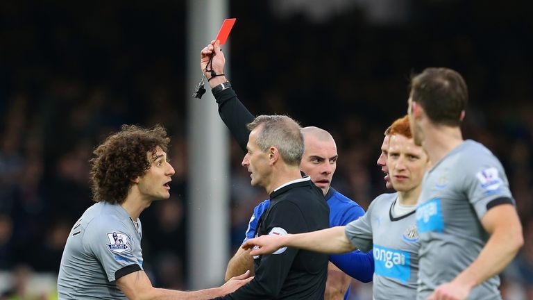 Referee Martin Atkinson shows Fabricio Coloccini of Newcastle United a red card during the Barclays Premier League match against Everton