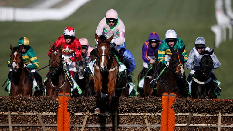 Ruby Walsh riding Faugheen clear the second flight of hurdles on their way to winning The Stan James Champion Hurdle at Che