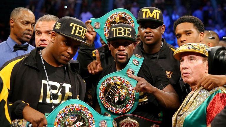 Floyd Mayweather Jr. shows off his world title belts following last year's win over Marcos Maidana