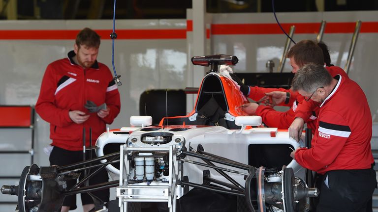 Manor work on their car in the garage in Australia