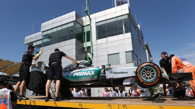 Lewis Hamilton's car is recovered to the pits