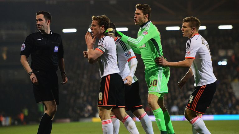 Scott Parker of Fulham leads the protests to referee Chris Kavanagh as Kostas Stafylidis of Fulham is sent off