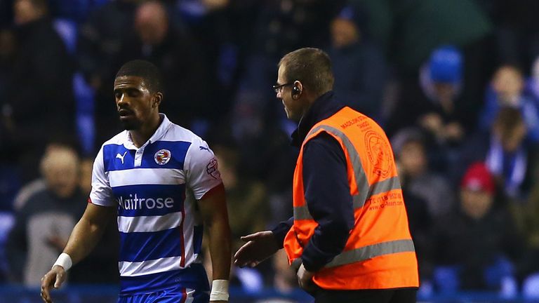 READING, ENGLAND - MARCH 16: Garath McCleary of Reading walks off for half time as James Hanson of Bradford City talks to referee Mike Jones during the FA 