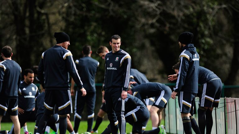 CARDIFF, WALES - MARCH 25:  Wales player Gareth Bale (c) shares a joke with Aaron Ramsey (r) during training ahead of this weekend's game against Israel at