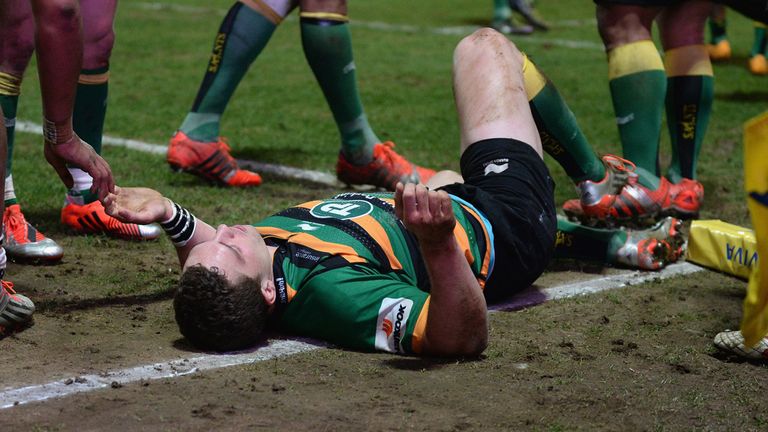 George North of Northampton Saints lays injured after colliding with Nathan Hughes of Wasps