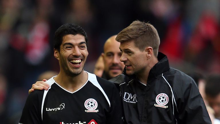 Luis Suarez and Steven Gerrard of the Gerrard XI share a laugh at full time following the Liverpool All-Star Charity match a