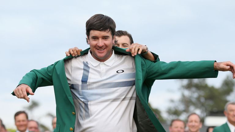 Adam Scott of Australia presents Bubba Watson of the United States with the green jacket